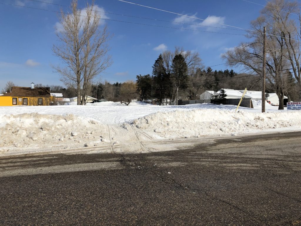 Tall snow banks across from Frederic Gas station